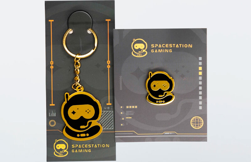 Spacestation Gaming Standard Issue keyring and pin © SSG shop
